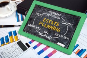 Green chalkboard showing an estate planning diagram surrounded by financial reports.
